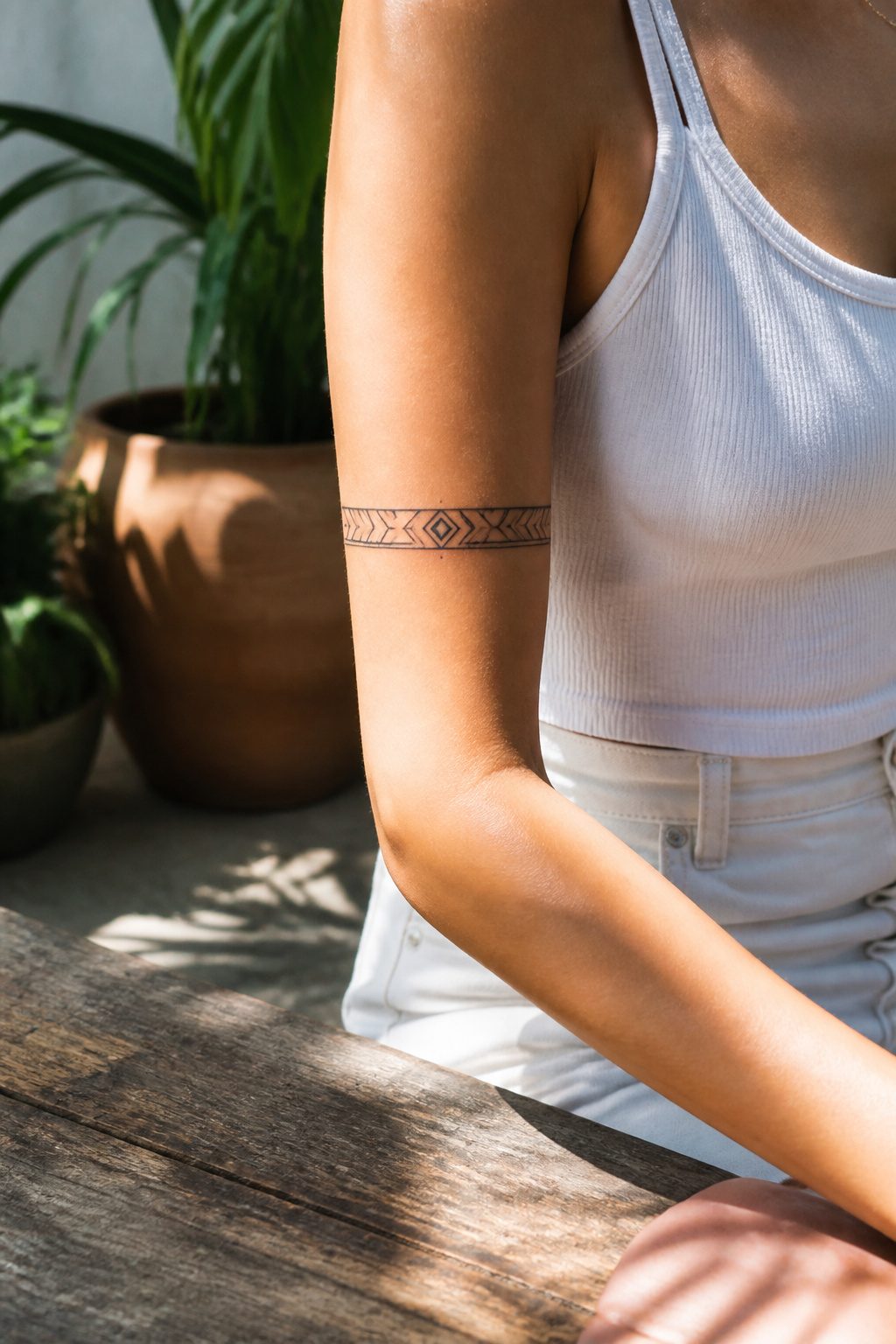 A geometric armband tattoo with clean lines on the upper arm.