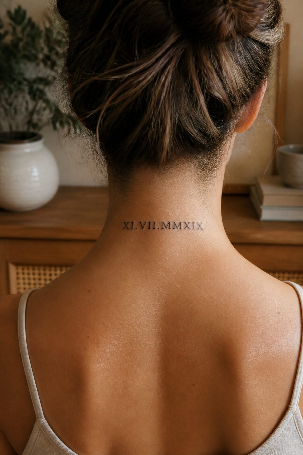 Tattoo of Roman numerals on the back of the neck.