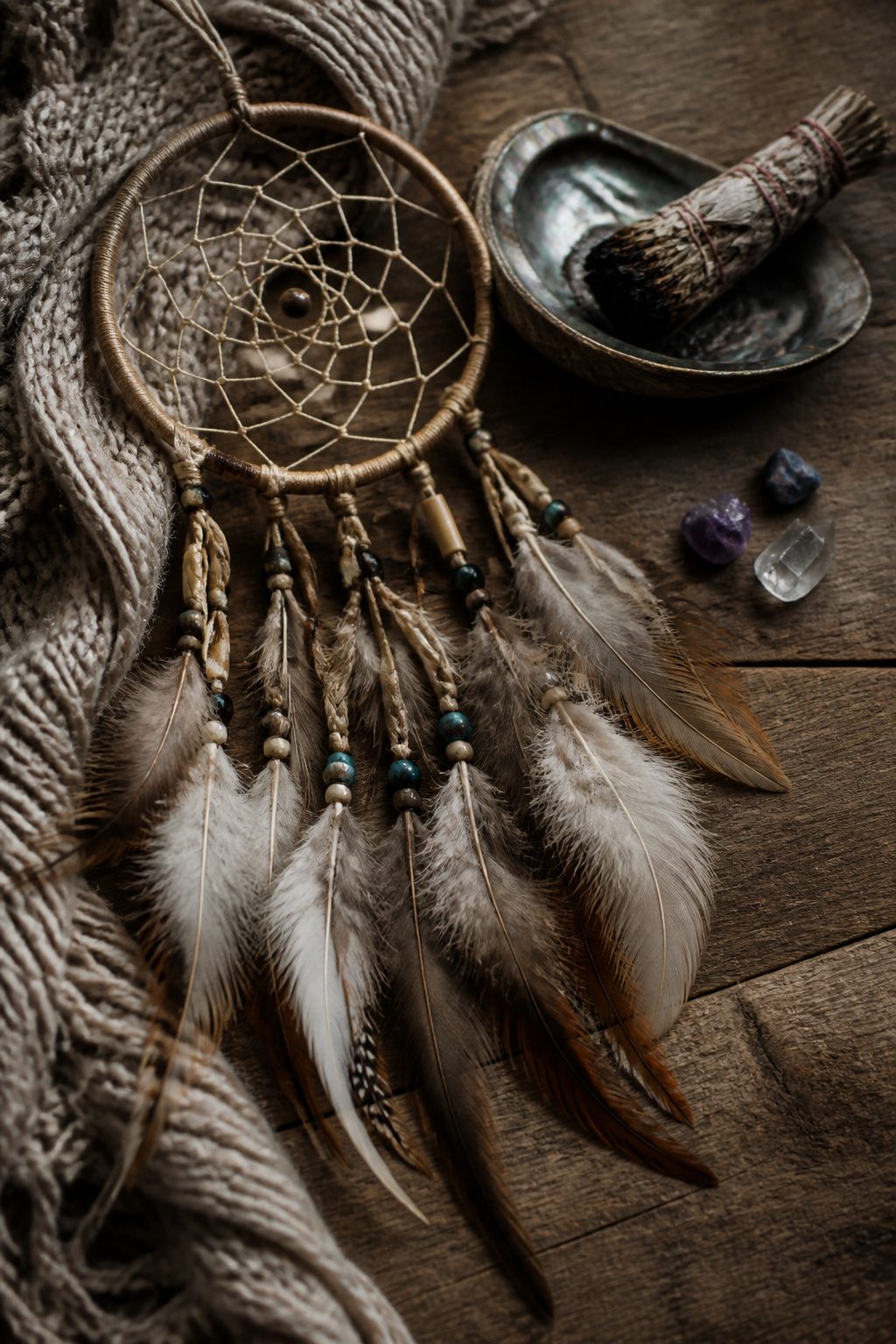 7 Back Tattoo Ideas for Women: Floral to Abstract Designs 2026 5 Still life representing dreamcatcher tattoos with feathers and beads.