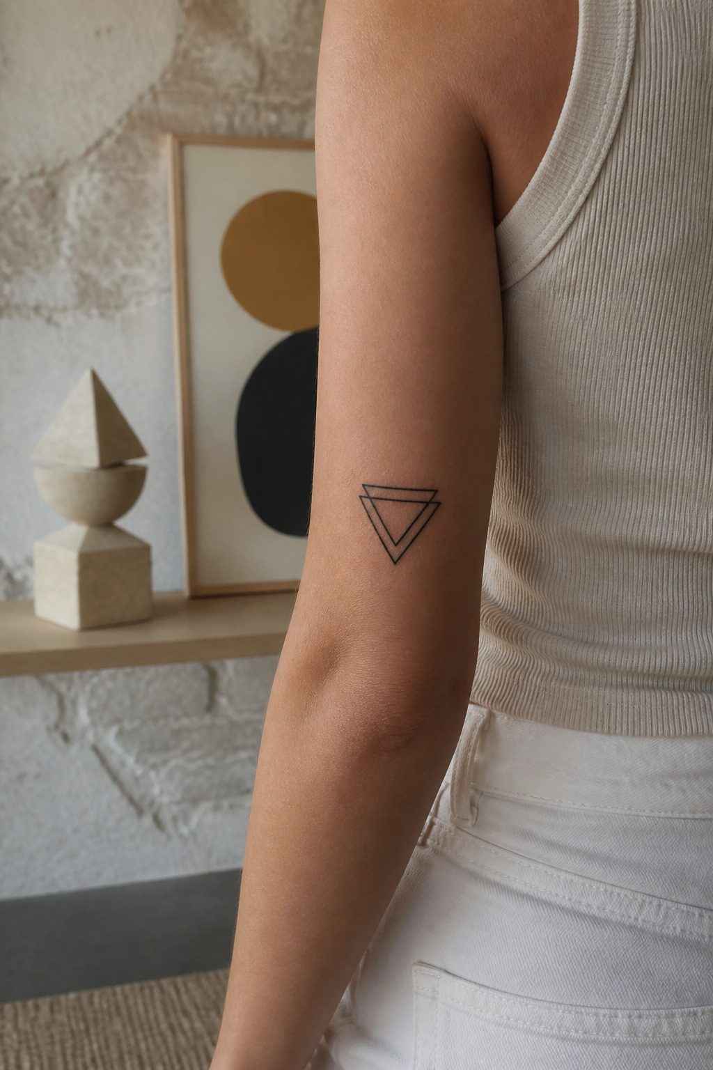 10 Dainty Tattoo Ideas for Women: Butterflies to Geometric Ink 9 Bold geometric triangle tattoo on an upper arm.