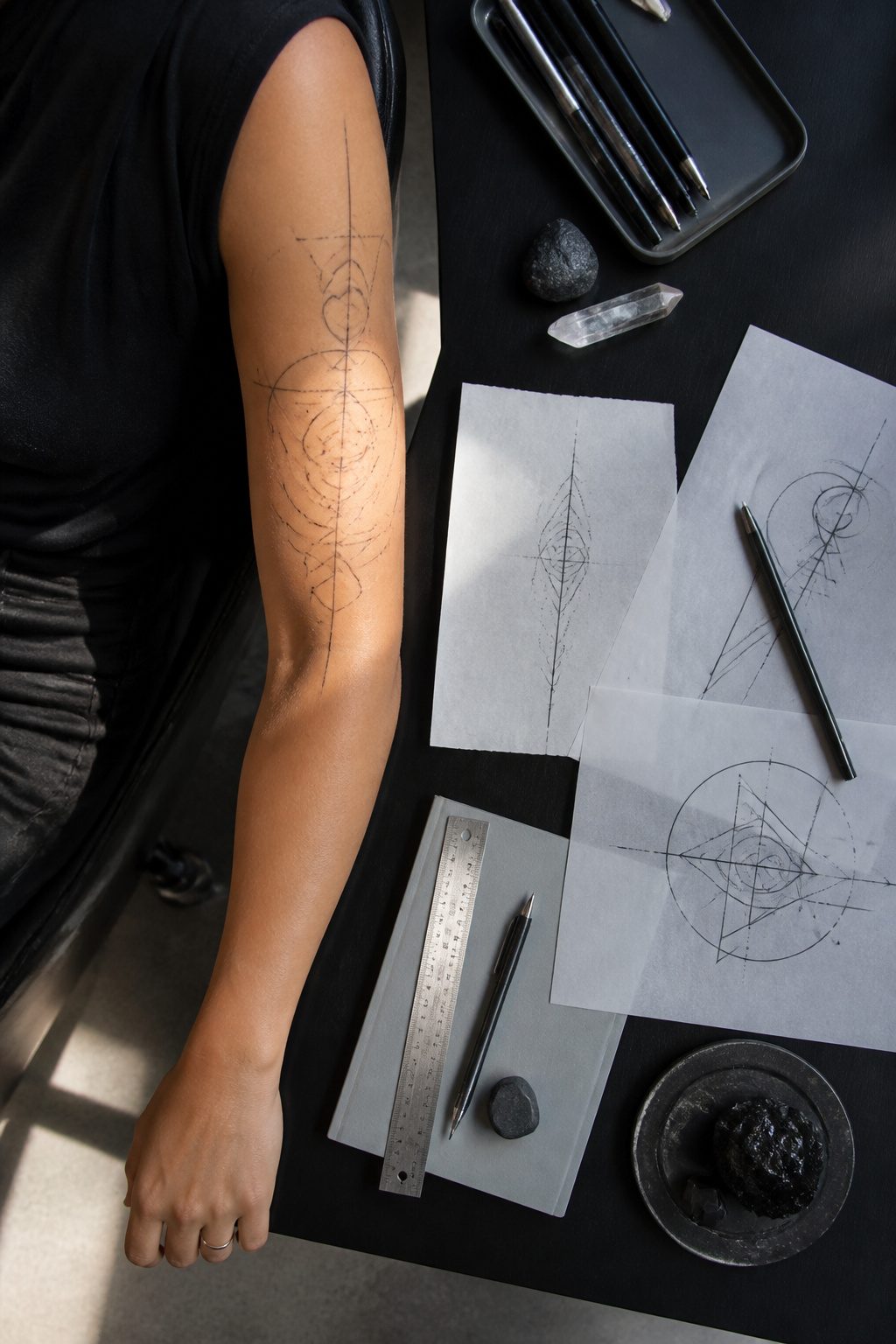 A collection of fine line geometric tattoos including mandalas and constellations.