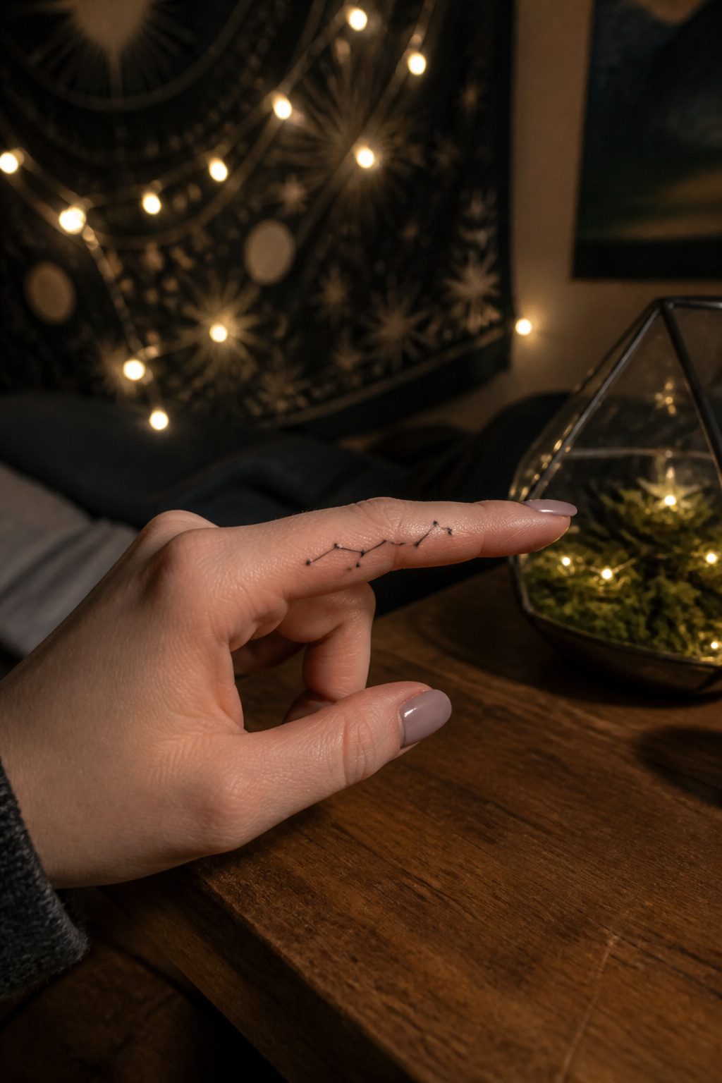 Constellation tattoo created with dots and lines on an index finger.