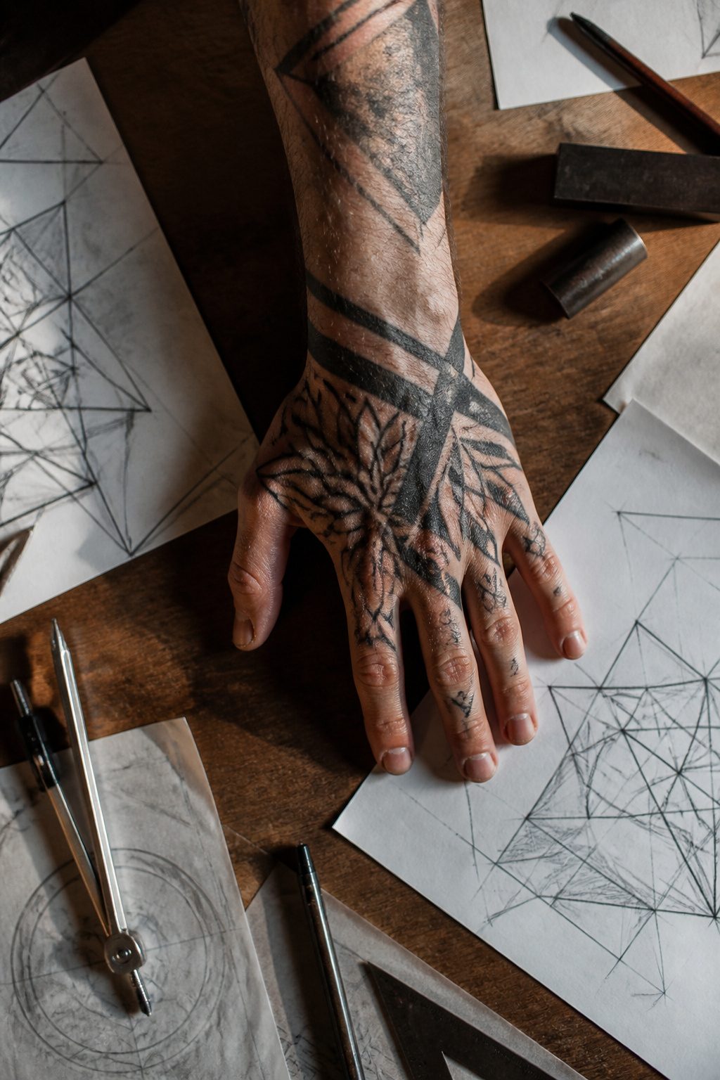 10 Hand Tattoo Ideas for Guys: Designs & Styles for 2026 6 Geometric tattoo patterns on a man's hand.