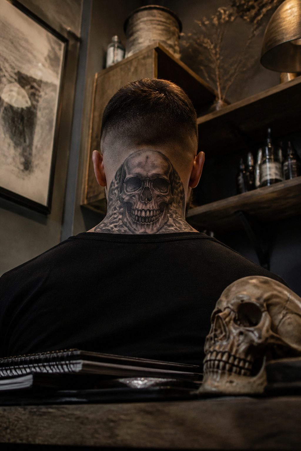 Skull tattoo on the neck with bold shading and intricate details.