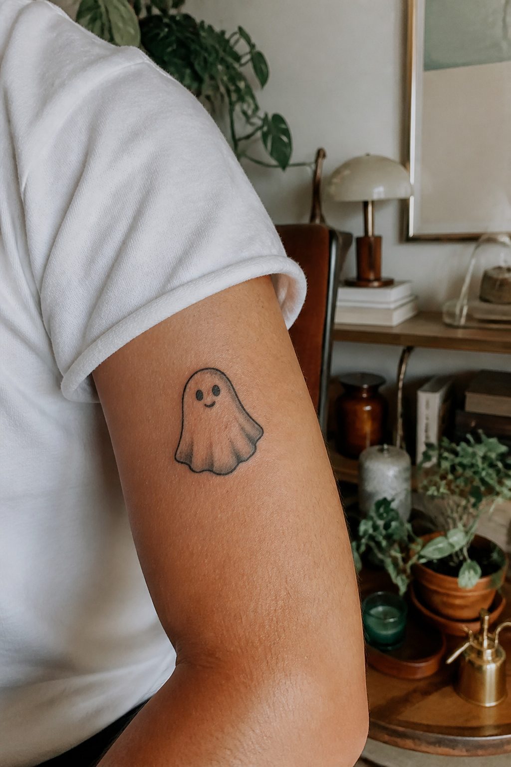 40 Small Tattoo Ideas for Men: Mini Designs That Mean Something 23 A playful ghost tattoo inked on a man's upper arm.